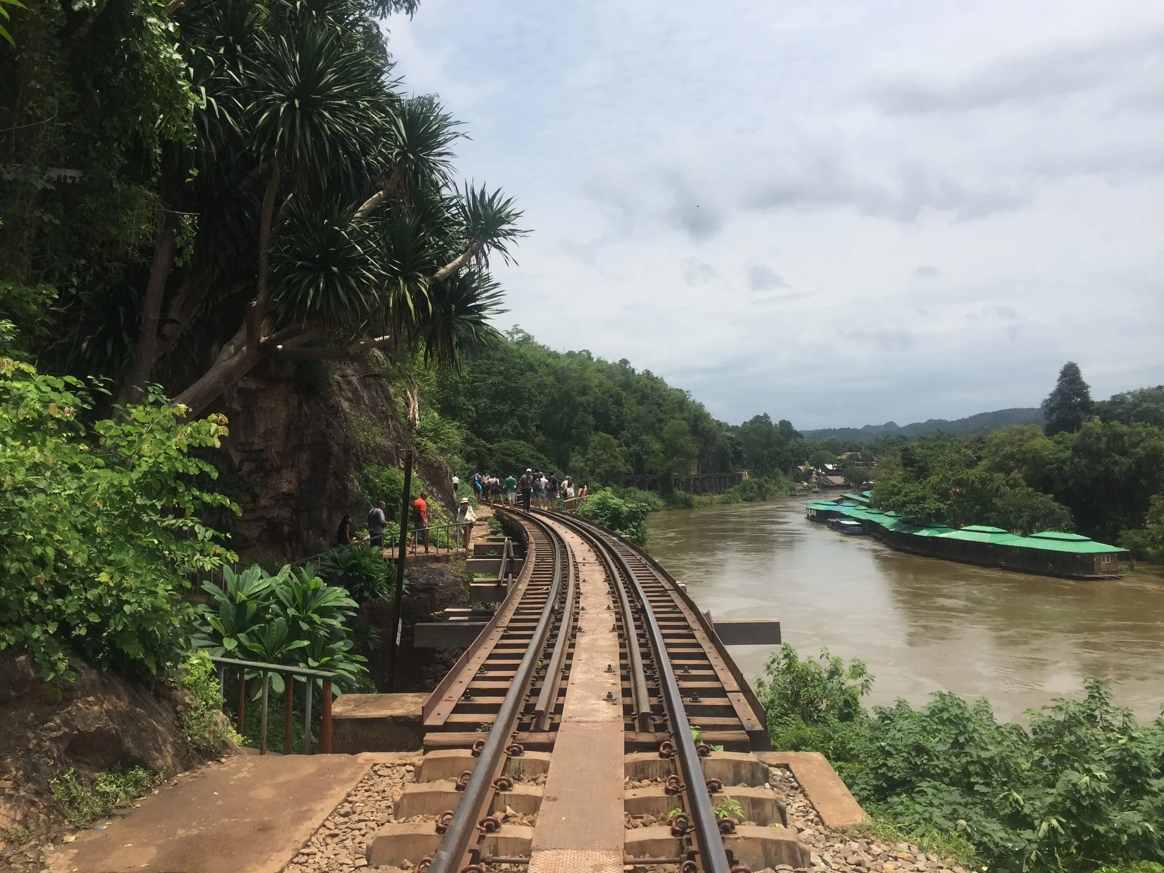 The Death Railway tracks curving along the cliff above the River Kwai.